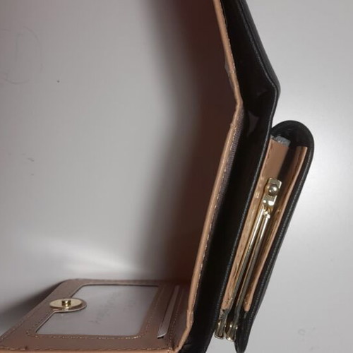 Black wallet new with gold emblem and beige lining