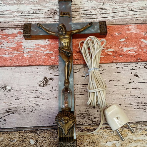 Old wooden crucifix used with bronze and light