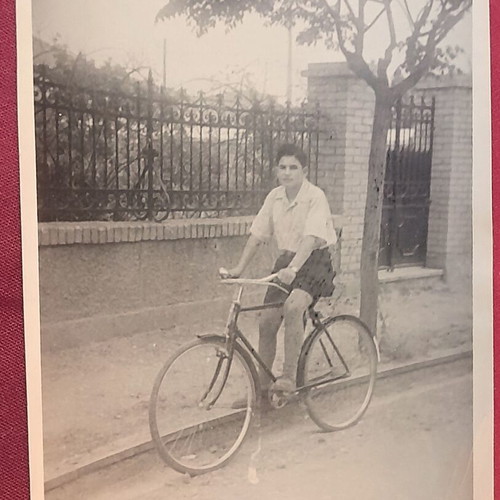 Vintage black and white photo of young man with bicycle