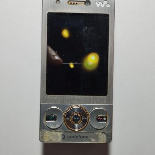 Sony Ericsson W715i mobile phone used, functional, with charger and headphones
