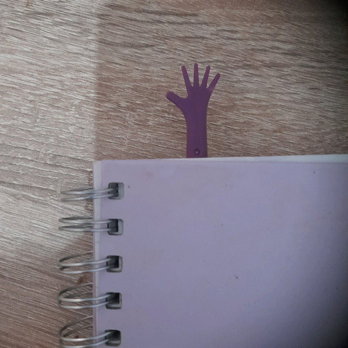 Plastic bookmark used, hand shape