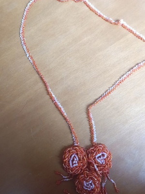 Long necklace with beads like new, mainly orange and pink