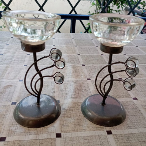 Set of table candle holders with dark metal base and crystal drop decorations