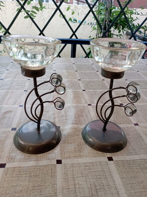 Set of table candle holders with dark metal base and crystal drop decorations