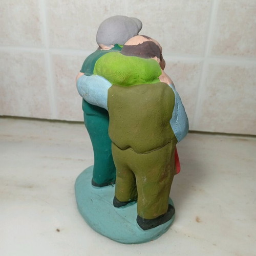 Ceramic figure of two men with traditional costumes like new