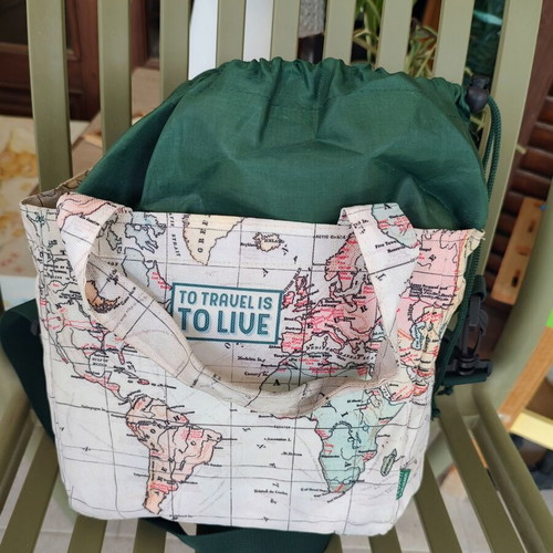 Tote bag with world map design "To Travel Is To Live"