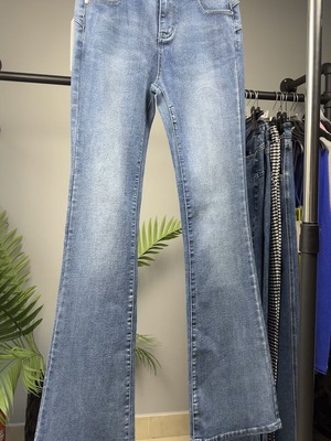 Light blue women's flared jeans with faded look