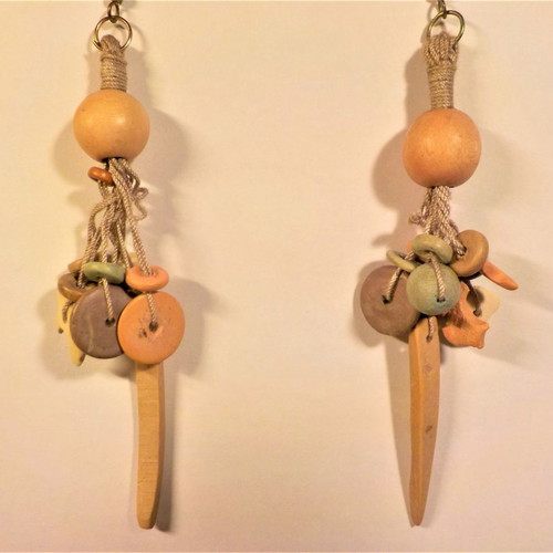 Long handmade earrings made of wood and cord in pastel colors