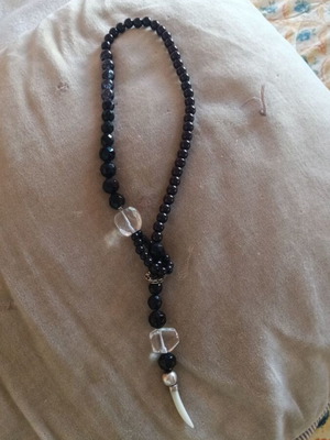 Necklace with black beads and white pendant, like new