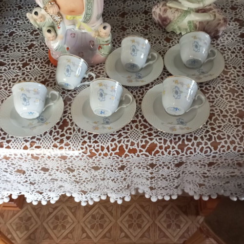 Porcelain coffee set used, light blue floral, missing one saucer