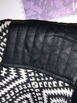 Jacket with pattern used, black and white, leather wear on shoulders