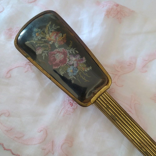 Old metal brush with embroidery used