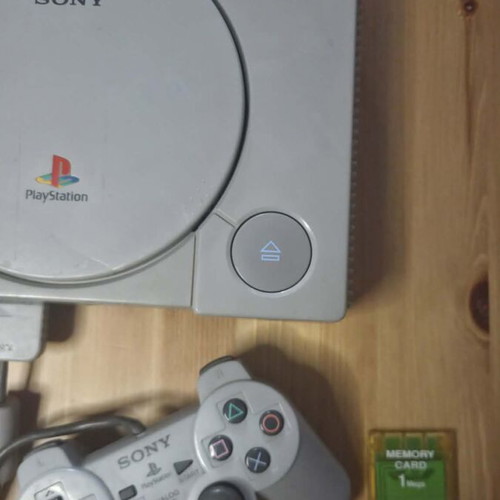 Sony PlayStation 1 console used with memory card, controller, and game