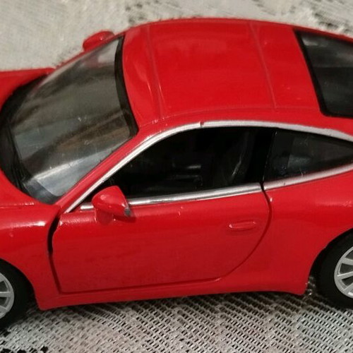 Collectible Porsche Carrera toy car with opening doors like new