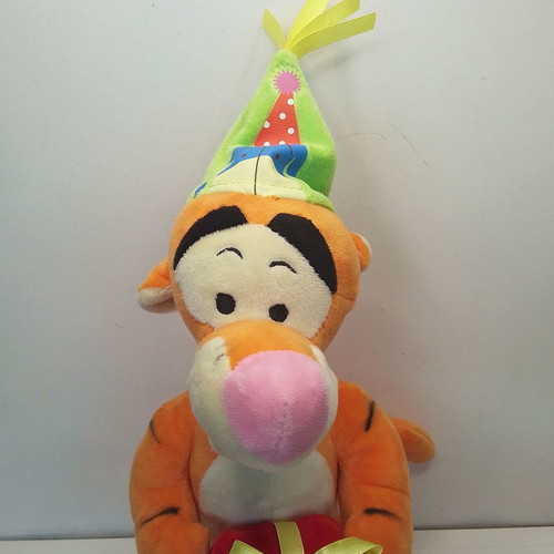 Disney Winnie Tigger plush used with birthday party hat
