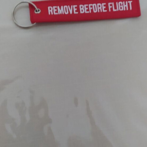 Remove Before Flight keychain new, red