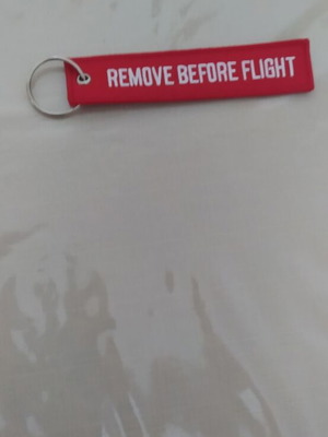 Remove Before Flight keychain new, red