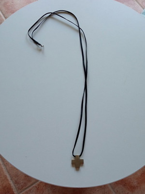 Silver cross with cord like new