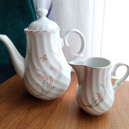 Porcelain teapot and creamer set like new with embossed designs