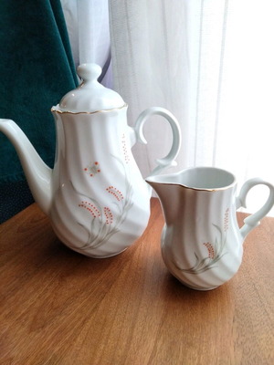 Porcelain teapot and creamer set like new with embossed designs