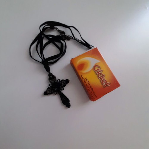 Black metal cross necklace like new with shiny stones on velvet ribbon