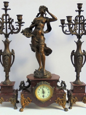 Metal clock with girl statue and marble base, French late 19th century