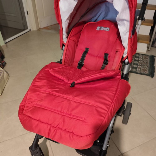 Kiddo Smart Deluxe stroller used with footmuff and changing bag, red