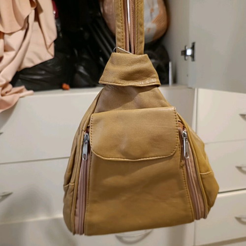 Leather backpack beige like new with multiple pockets and zippers