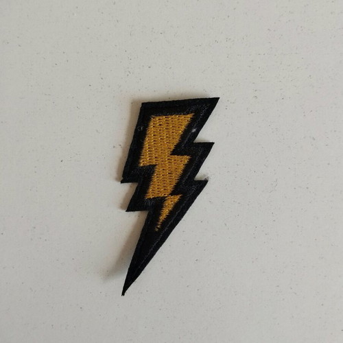 Sewn patch in gold lightning bolt shape like new