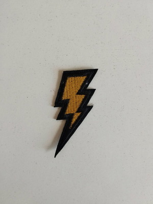 Sewn patch in gold lightning bolt shape like new