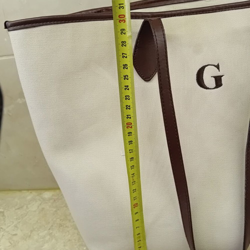 Large beige fabric shoulder bag with brown leather details