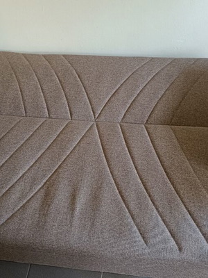 Two-seater sofa bed with storage space