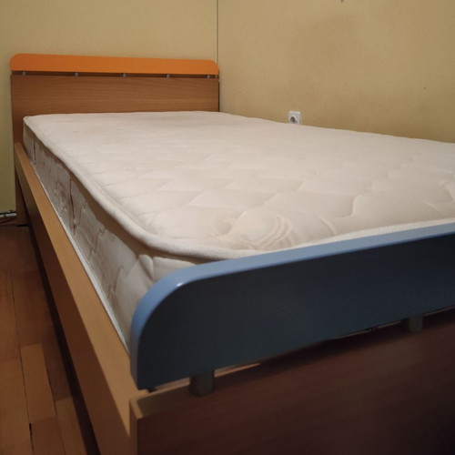 Neoset single bed used with mattress, blue and orange details