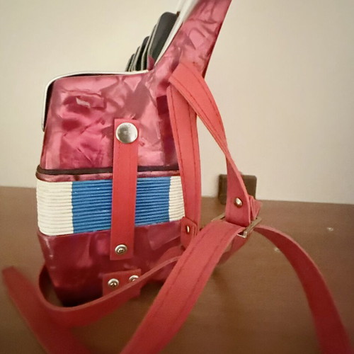 Children's accordion used, red with blue and red bellows