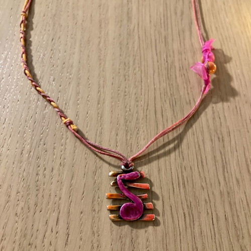 Necklace with musical note on staff, silver motif