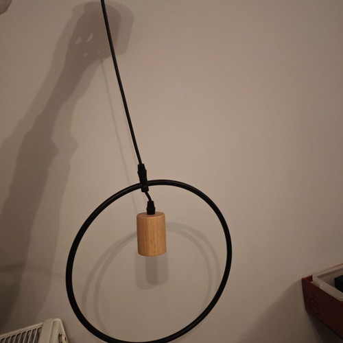 Pendant light used with black metal frame and wooden detail