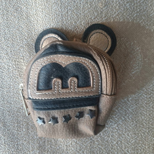 Coin purse used in mini backpack shape with decorative ears and letter M
