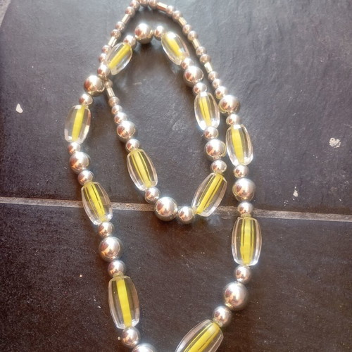 Vintage statement necklace used with graduated lucite beads and silver spheres
