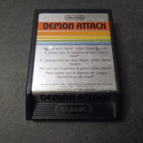 Atari 2600 VCS Woody console used with two joysticks and Demon Attack game