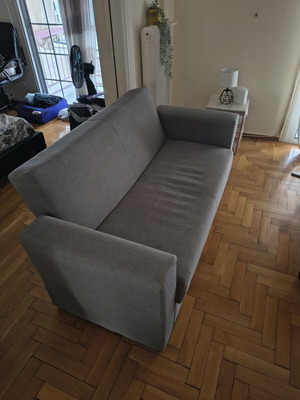 Two-seater sofa with storage and bed function