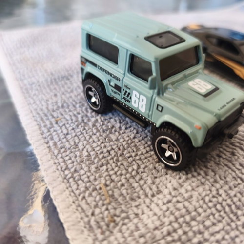 Land Rover Defender and Cord Camaro toy cars, set of 2