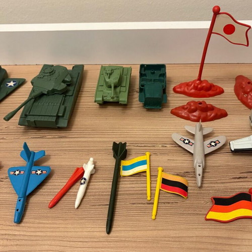 Vintage plastic military toys used with vehicles, flags and rockets