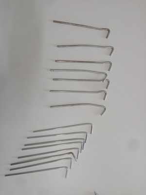 Tent pegs set like new, 7 hard steel and 8 thin pegs