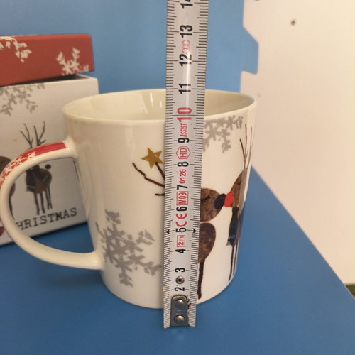 Christmas-themed mug with two reindeer