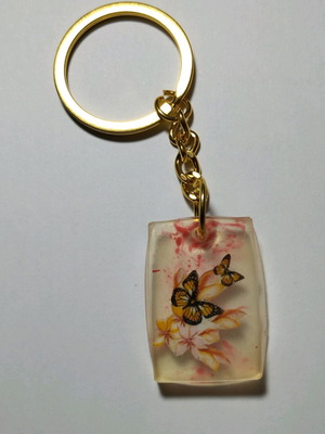 Handmade butterfly keychain from resin like new, white multicolor