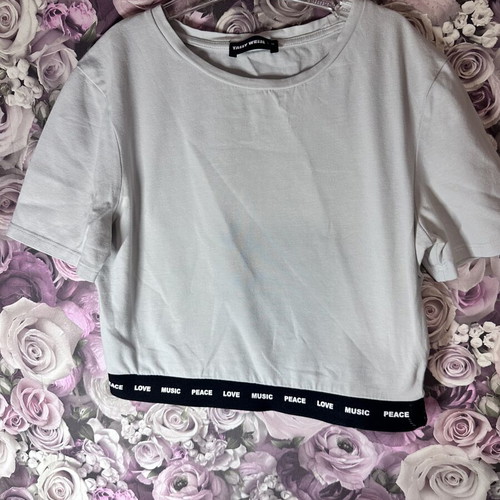 White short-sleeve crop top with black elastic band, size M