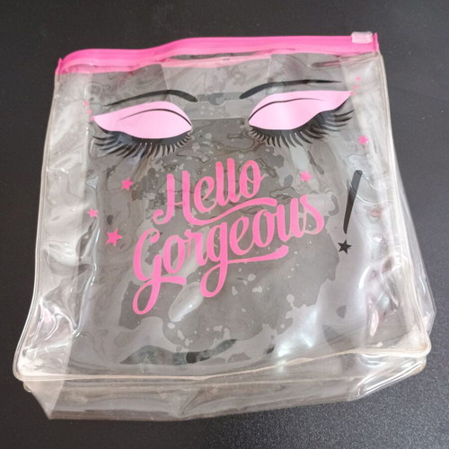 Transparent pink toiletry bag used