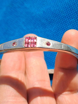 Silver hinged bracelet used with pink crystals, modern style