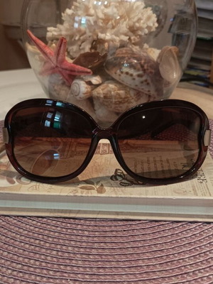 Polaroid polarized sunglasses, brown oval frame with gold accents
