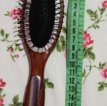 Small hairbrush with metal pins and rubber cushion